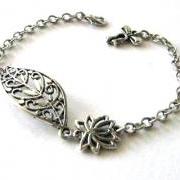 Antiqued silver filigree leaf bracelet jewelry with lotus flower and bow charm