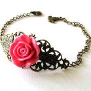 Fuchsia pink resin flower bracelet jewelry with bronzed filigree and bird charm